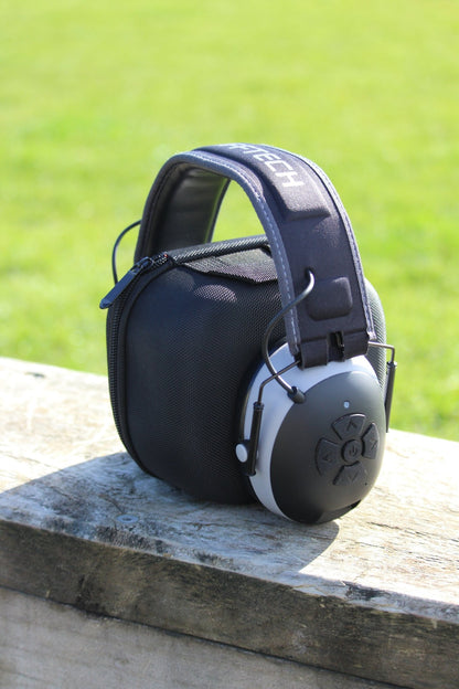 Mufftech Double OG Bluetooth earmuffs and carry case on outdoor wooden plank, jobsite-ready