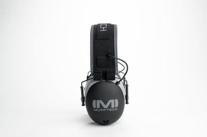 Side profile of Mufftech Double OG earmuffs showing M logo on silver earcup