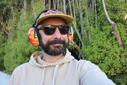 Tradie wearing Mufftech Orange Roughy Bluetooth earmuffs outdoors, lightweight comfort for all-day wear
