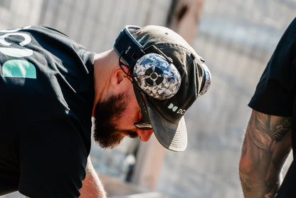 Carpenter on site working with timber while wearing Mufftech Sole noise-reducing earmuffs
